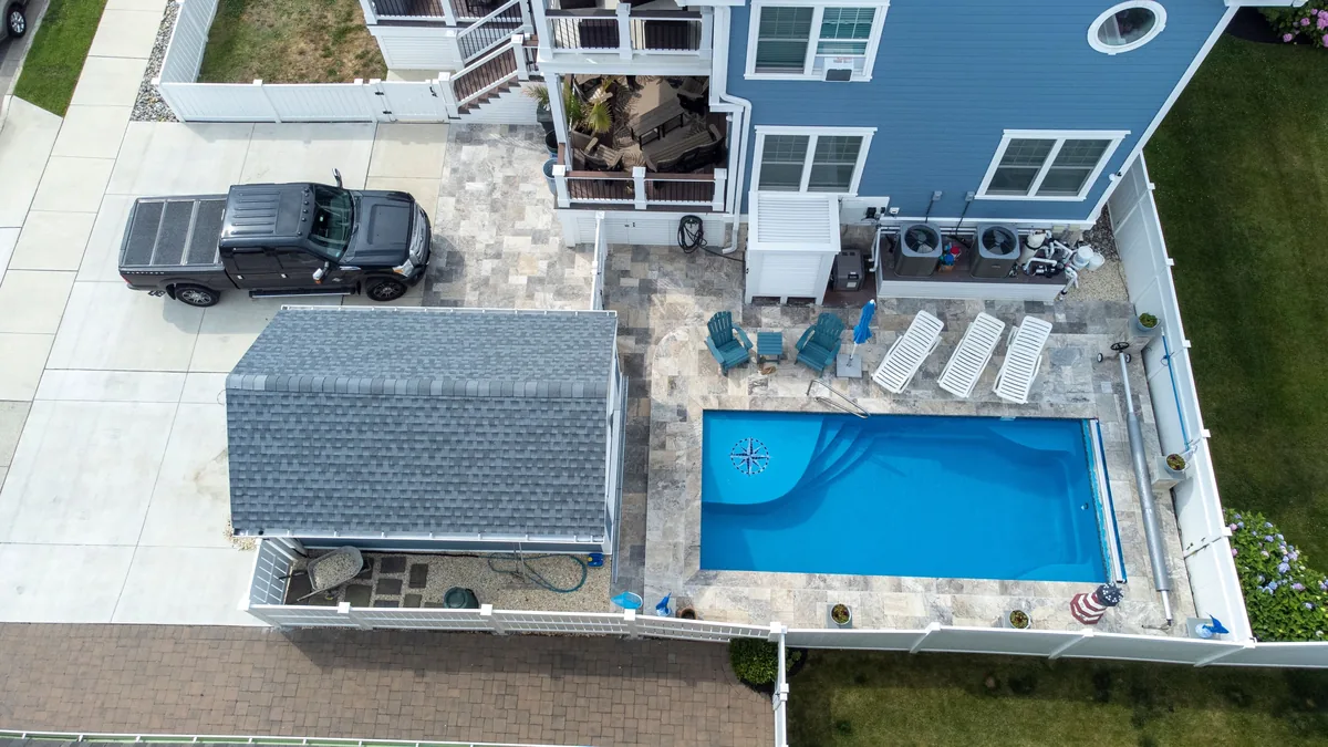 A finished pool and patio from above
